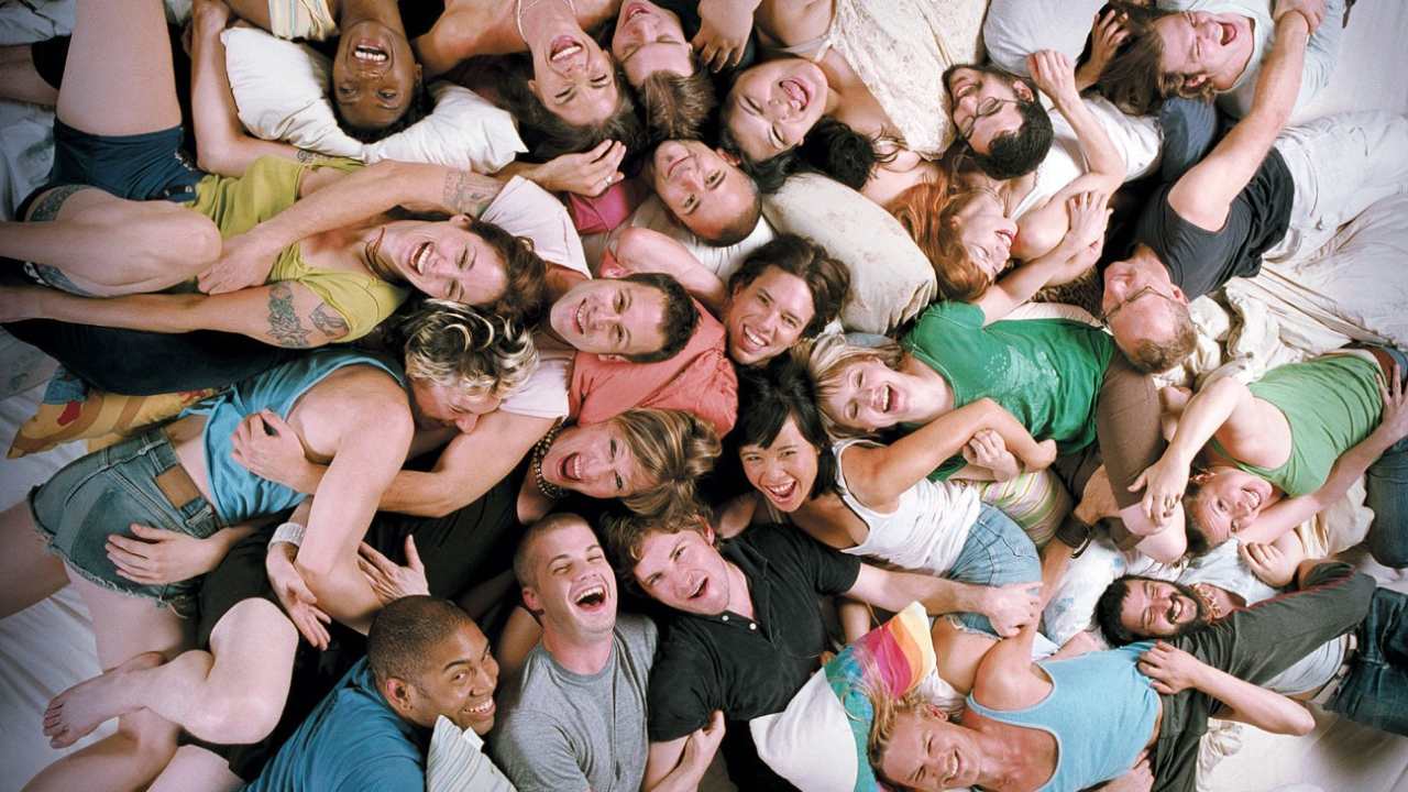 a group of people smiling and laying down together